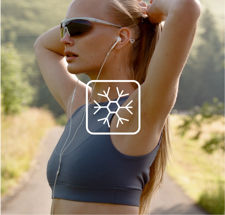 Woman in a navy top on a trail with a snowflake icon