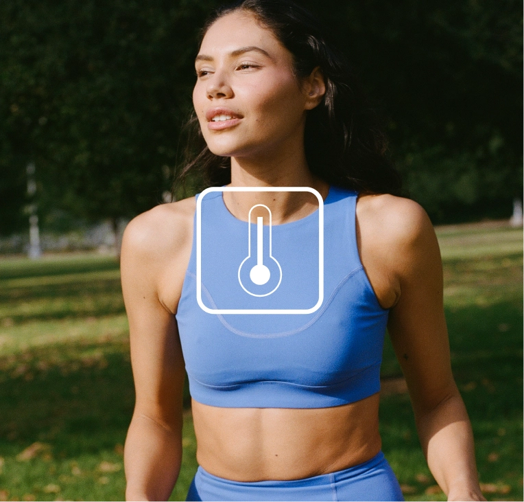 Woman in a blue top outdoors with a thermometer icon