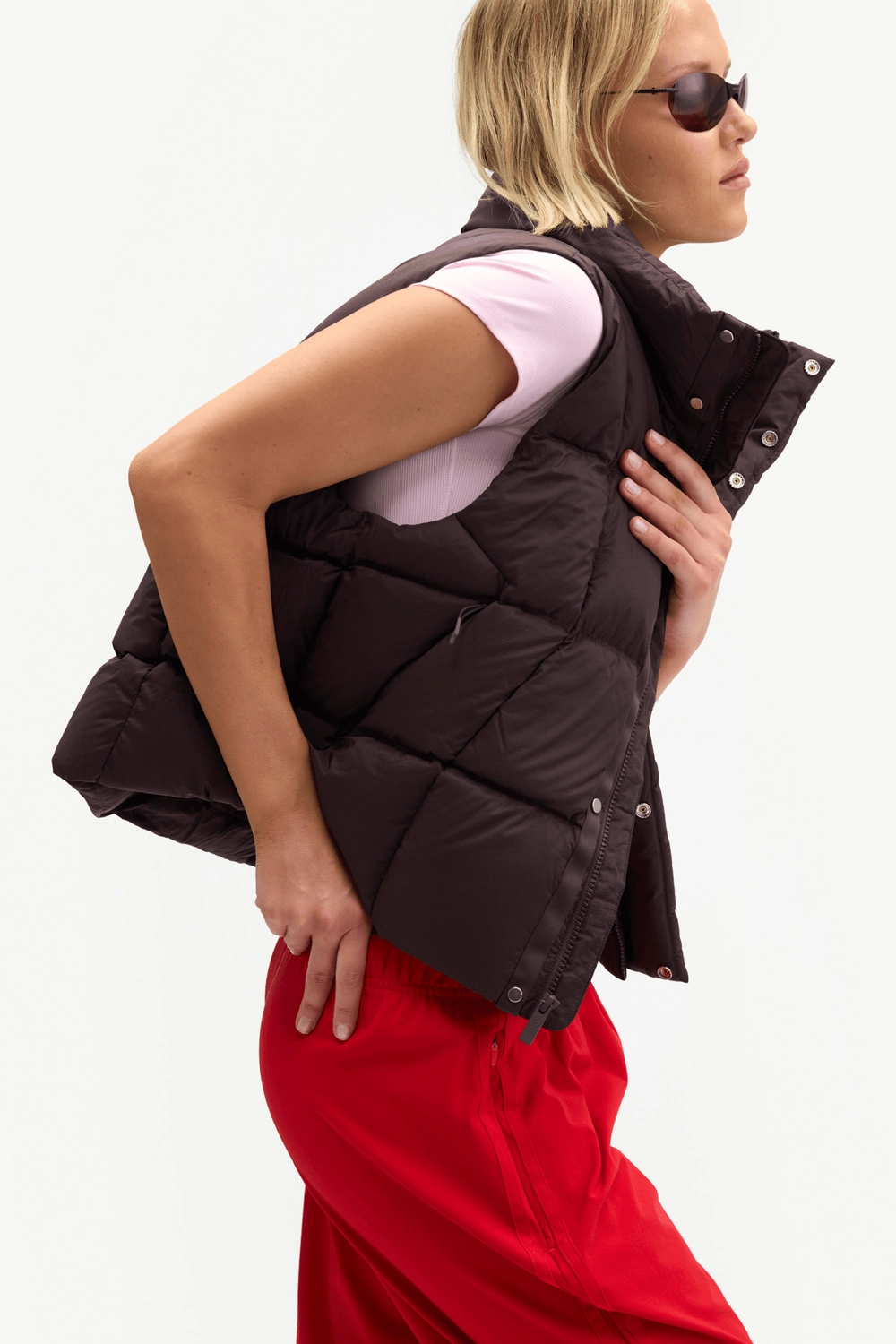 Dark brown Louise Down Vest worn with red pants